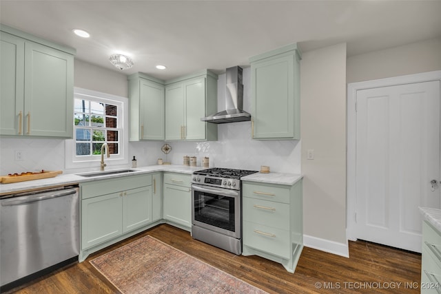 kitchen featuring sink, wall chimney range hood, stainless steel appliances, and dark hardwood / wood-style flooring