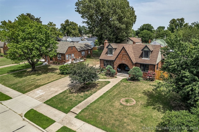 english style home with a front lawn