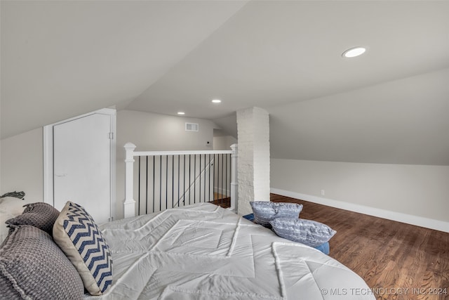 bedroom with wood-type flooring and lofted ceiling