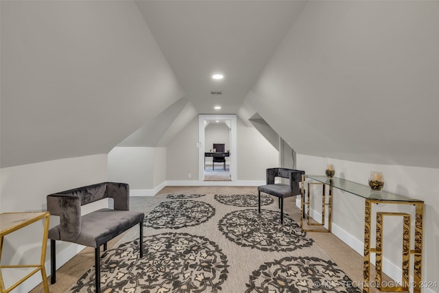 interior space featuring light carpet and lofted ceiling