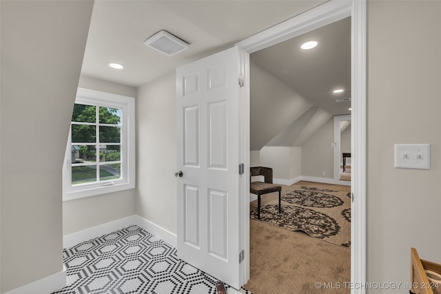 additional living space featuring light colored carpet