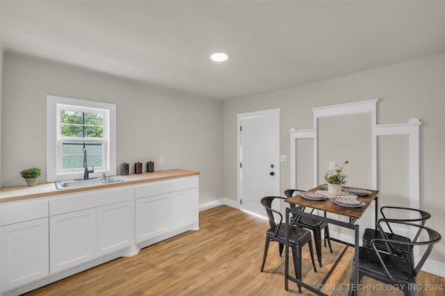 dining room featuring light wood-type flooring and sink