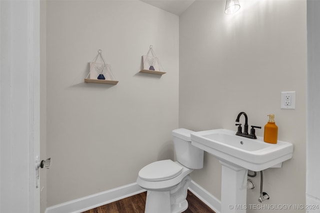 bathroom with wood-type flooring and toilet