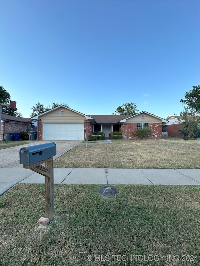 ranch-style house with a garage and a front yard