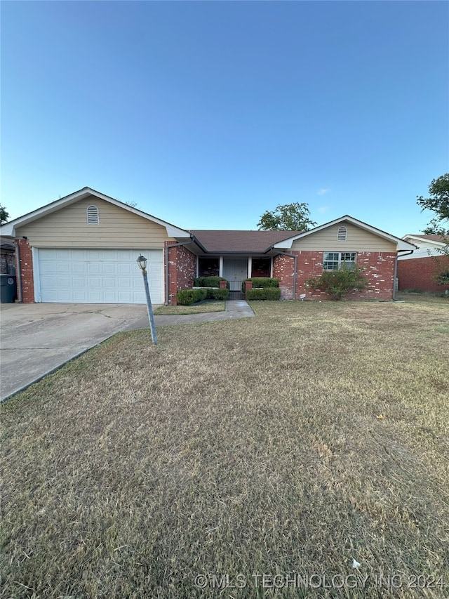 ranch-style home with a front yard and a garage