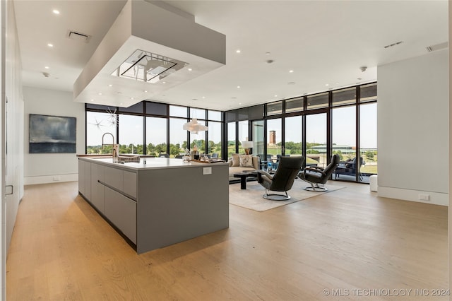 interior space with floor to ceiling windows, a healthy amount of sunlight, and a large island