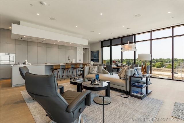 living room with floor to ceiling windows and sink