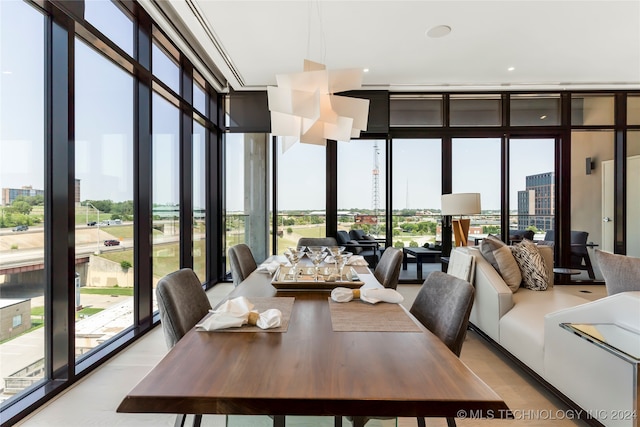 dining room with floor to ceiling windows and a healthy amount of sunlight