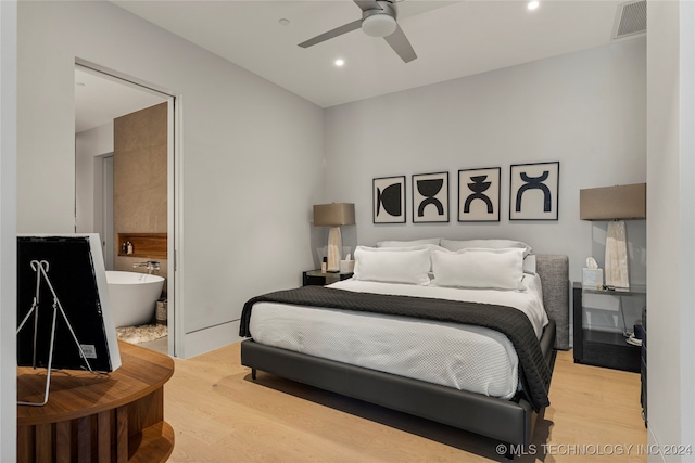 bedroom with ceiling fan, ensuite bathroom, and light hardwood / wood-style floors