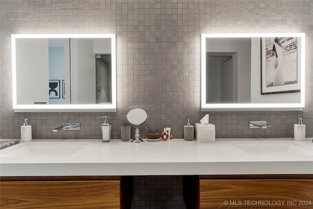 bathroom featuring decorative backsplash, tile walls, and vanity