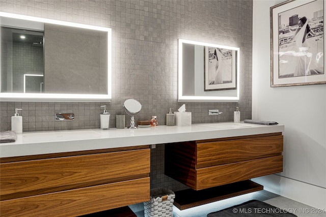 bathroom featuring tile patterned floors, vanity, and tasteful backsplash