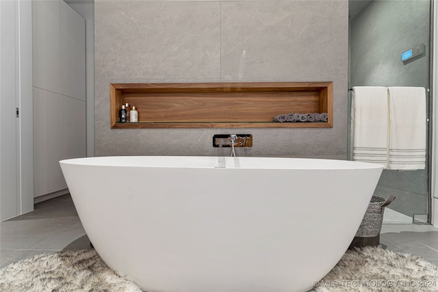 bathroom featuring tile patterned floors and a washtub