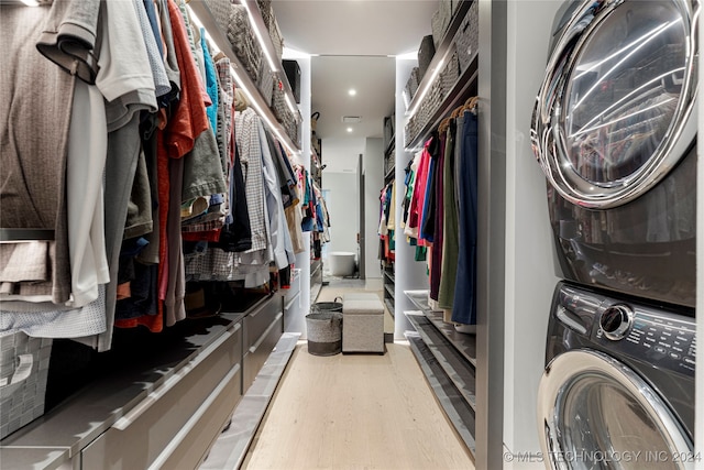 interior space featuring stacked washer and clothes dryer and light hardwood / wood-style floors