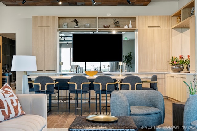 interior space with beamed ceiling and light hardwood / wood-style flooring