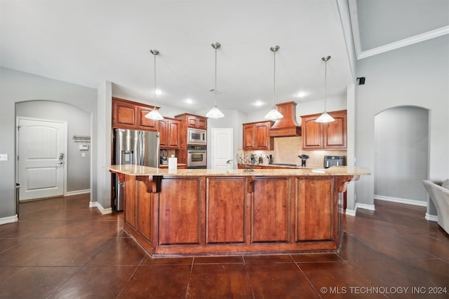 kitchen with appliances with stainless steel finishes, hanging light fixtures, custom exhaust hood, and an island with sink