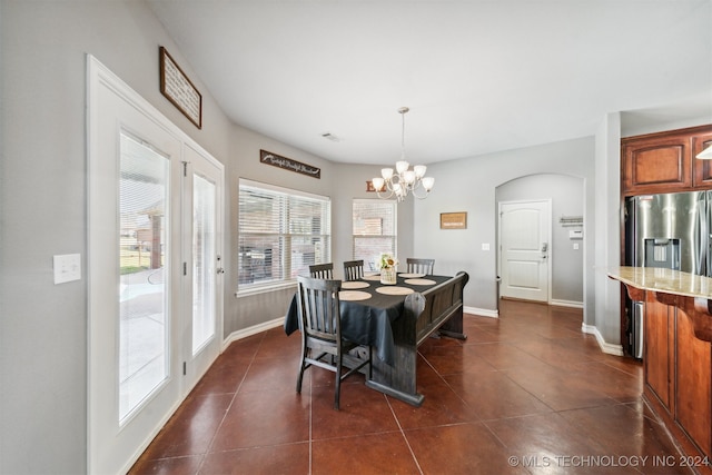 tiled dining area featuring a notable chandelier