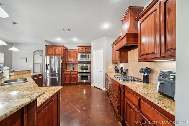 kitchen featuring pendant lighting, dark tile patterned flooring, sink, stainless steel appliances, and decorative backsplash