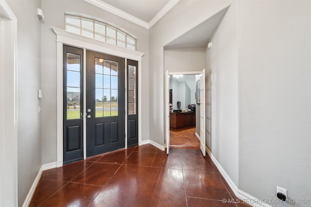 foyer entrance with crown molding and dark wood-type flooring