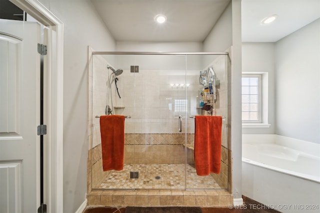 bathroom featuring independent shower and bath