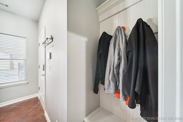 mudroom with dark tile patterned flooring