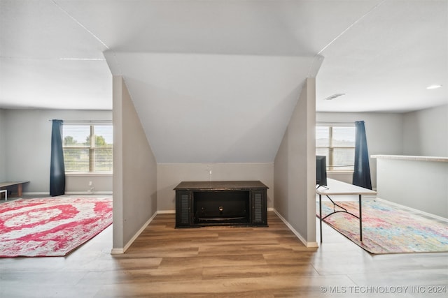 bedroom with hardwood / wood-style flooring and lofted ceiling