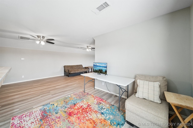 sitting room with wood-type flooring and ceiling fan