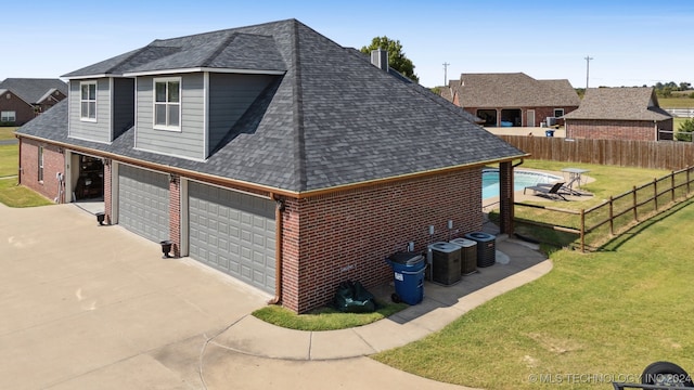 view of home's exterior featuring a garage and a lawn