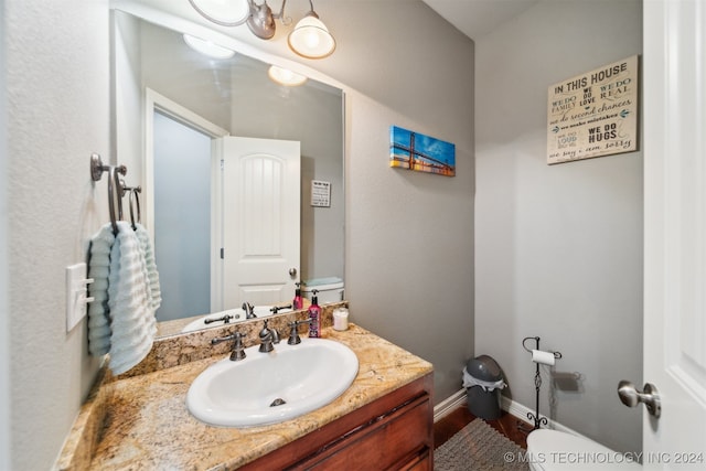 bathroom featuring vanity and toilet