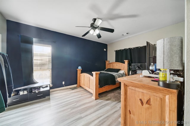 bedroom with ceiling fan and light hardwood / wood-style flooring