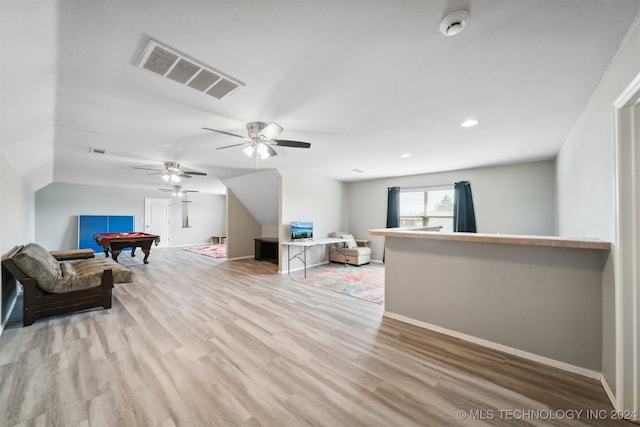 living room featuring pool table, bar, ceiling fan, and light hardwood / wood-style flooring