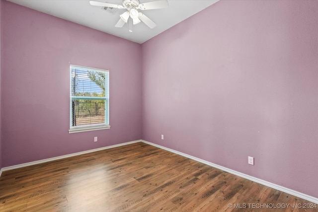 unfurnished room featuring ceiling fan and dark wood-type flooring