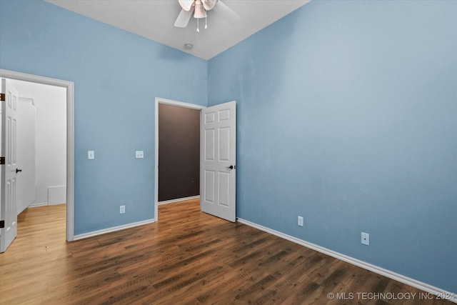 unfurnished bedroom featuring baseboards, a ceiling fan, and wood finished floors