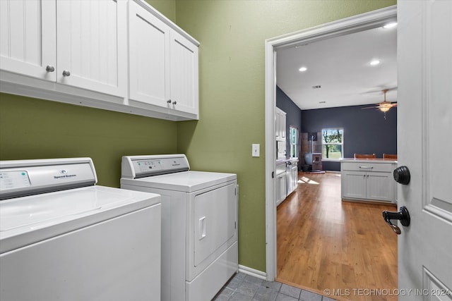 laundry room with separate washer and dryer, light hardwood / wood-style flooring, ceiling fan, and cabinets