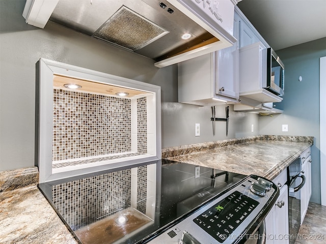 kitchen featuring white cabinetry and extractor fan