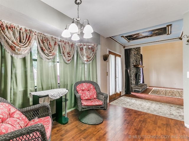 sitting room with an inviting chandelier and wood-type flooring