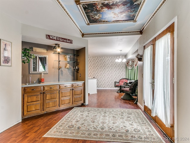 bathroom with a notable chandelier, hardwood / wood-style flooring, vanity, and crown molding