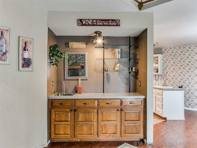 bathroom featuring wood-type flooring and sink