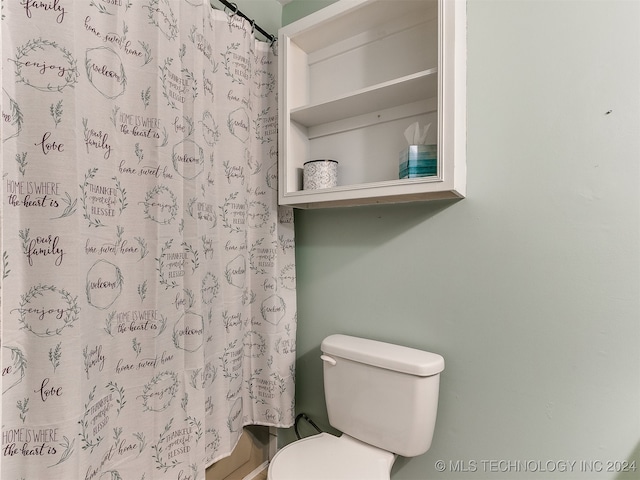 bathroom featuring walk in shower and toilet