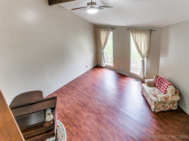 living area with ceiling fan, vaulted ceiling with beams, and hardwood / wood-style floors