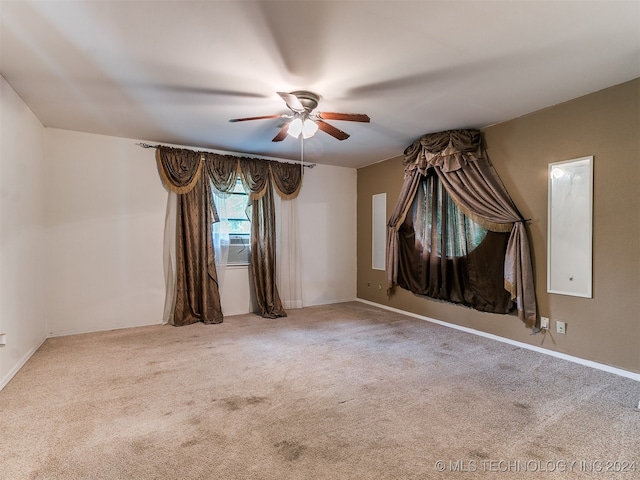 spare room with carpet floors and ceiling fan