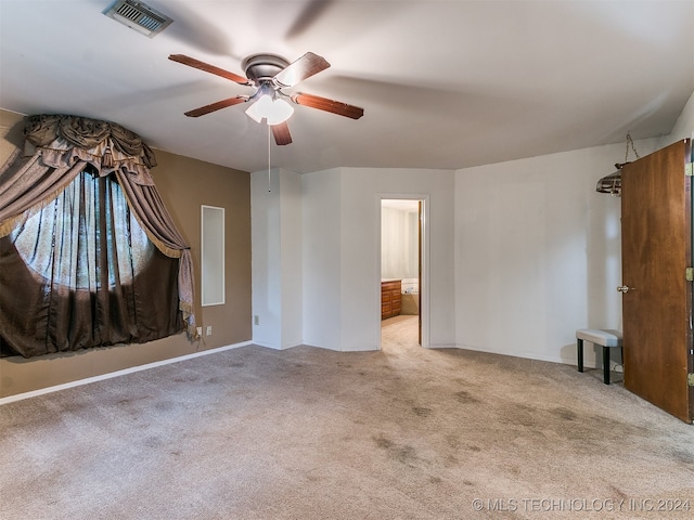 carpeted spare room featuring ceiling fan