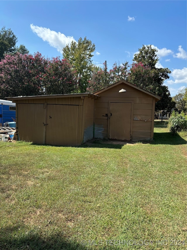 view of outbuilding featuring a yard