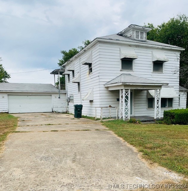 view of front of property featuring a garage and a front lawn