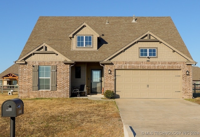 view of front of house with a front yard and a garage