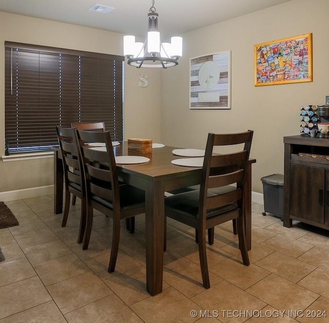 tiled dining area with a notable chandelier