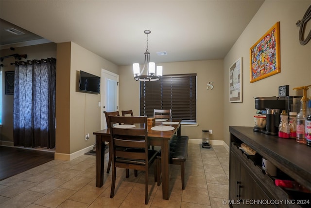 dining room with an inviting chandelier and light tile patterned flooring