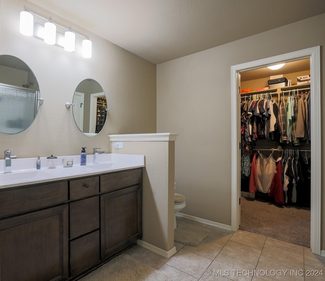 bathroom featuring tile patterned floors, vanity, and toilet