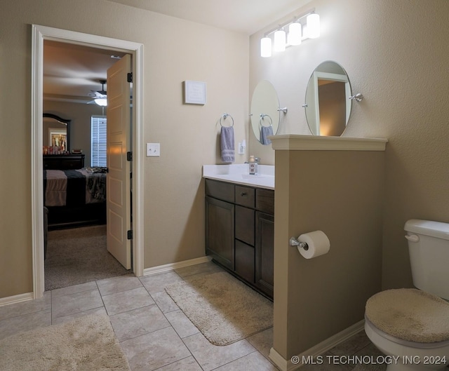 bathroom featuring tile patterned floors, vanity, and toilet