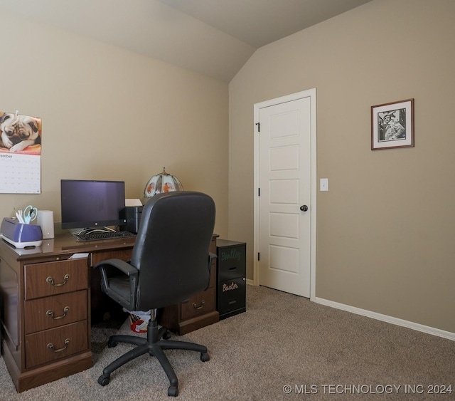 carpeted office featuring vaulted ceiling