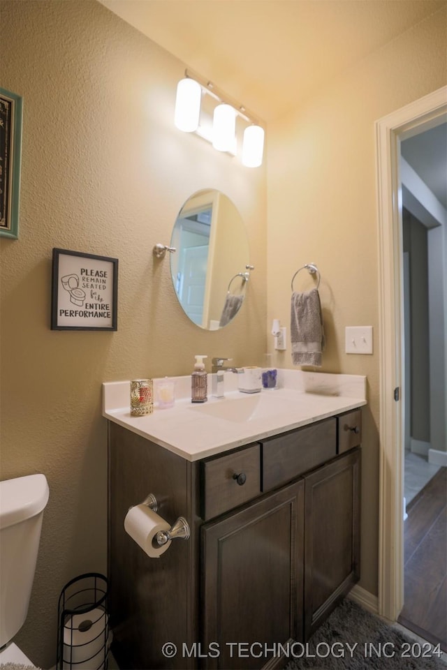 bathroom featuring vanity and toilet